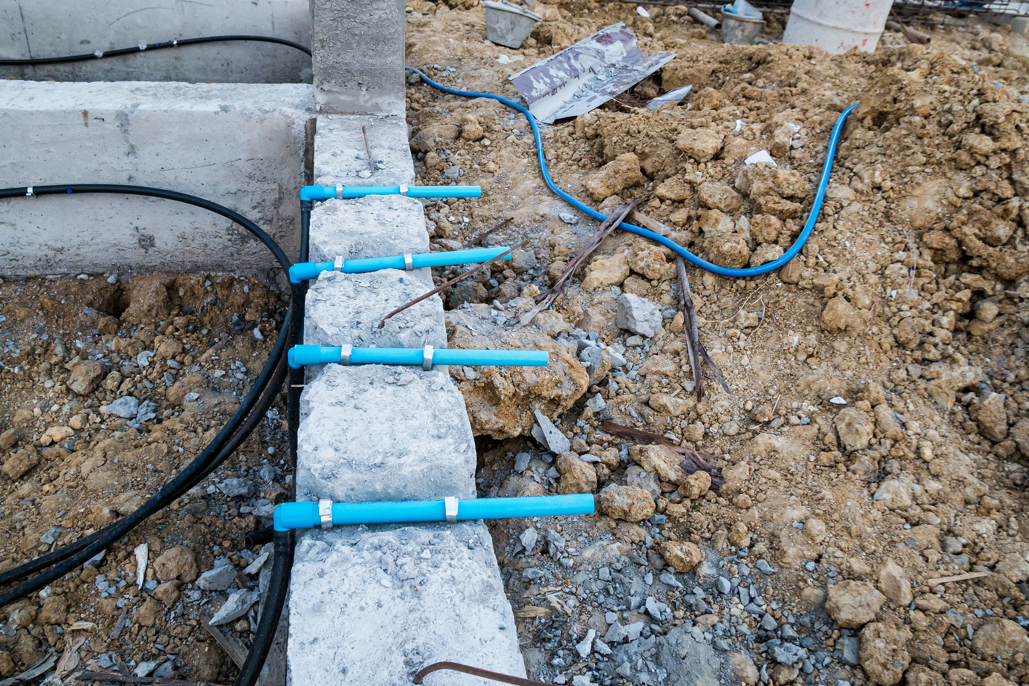 794148271 Pest control pipe system install at new house construction foundation for termite protection